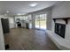 Open-concept living space featuring wood flooring, a fireplace, and modern kitchen at 4715 Greensprings Rd, College Park, GA 30337