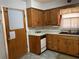 Classic kitchen featuring wood cabinets, a double basin sink, and a door to the side yard at 475 Maxwell Rd, Roswell, GA 30075