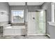 Bright bathroom featuring a soaking tub under a window and a glass-enclosed shower at 113 Willow Hill Ln, Stockbridge, GA 30281