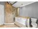 Bathroom featuring a stand alone glass shower, bathtub, and a toilet at 113 Willow Hill Ln, Stockbridge, GA 30281