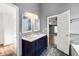 Bathroom with double vanity, stylish fixtures, and an open doorway to the Primary bedroom at 113 Willow Hill Ln, Stockbridge, GA 30281