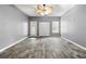 Spacious bedroom with wood-look flooring, ceiling fan, and plenty of natural light at 113 Willow Hill Ln, Stockbridge, GA 30281