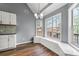 Corner view of breakfast nook with bright windows, modern lighting and a view of the kitchen at 113 Willow Hill Ln, Stockbridge, GA 30281