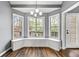 Bright breakfast nook with bay windows, built-in seating, and hardwood floors at 113 Willow Hill Ln, Stockbridge, GA 30281