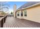 A wooden deck wraps around this home, with a view of the home's exterior and chimney at 113 Willow Hill Ln, Stockbridge, GA 30281