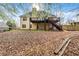 Rear exterior of the home showing the deck, stairs, patio and fenced yard at 113 Willow Hill Ln, Stockbridge, GA 30281