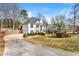 Expansive home featuring a long driveway, well-manicured lawn, and lush landscaping at 113 Willow Hill Ln, Stockbridge, GA 30281