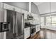 Modern kitchen featuring stainless steel appliances, white cabinets, and granite countertops at 113 Willow Hill Ln, Stockbridge, GA 30281
