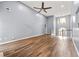 Sun-filled living room with tall ceilings, wood-look floors, and neutral walls at 113 Willow Hill Ln, Stockbridge, GA 30281