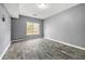 Neutral room with wood-look flooring and large window for plenty of natural light at 113 Willow Hill Ln, Stockbridge, GA 30281