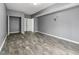 Spacious room with wood-look flooring, and access to the closet and another room at 113 Willow Hill Ln, Stockbridge, GA 30281