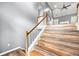 View of the wooden staircase with gray walls, wood-look floors and white trim at 113 Willow Hill Ln, Stockbridge, GA 30281