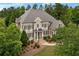 Stunning aerial view of home with a large roof, lush landscaping, and mature trees at 19 Troup Ct, Acworth, GA 30101