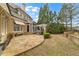 Spacious backyard features a stone patio, screened porch, lush landscaping, and mature trees at 19 Troup Ct, Acworth, GA 30101