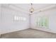 Clean, bright room with light-colored walls, carpet flooring, crown molding and multiple windows with shutter blinds at 19 Troup Ct, Acworth, GA 30101