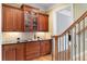 Butler's pantry area features stained wood cabinetry, granite counters, and tile backsplash at 19 Troup Ct, Acworth, GA 30101