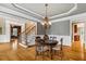 Dining area with hardwood floors, chandelier, and access to the staircase and kitchen at 19 Troup Ct, Acworth, GA 30101