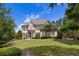 Beautiful front exterior view, showing the well-kept lawn and mature trees at 19 Troup Ct, Acworth, GA 30101