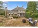 Rear exterior showcasing a large home with a patio, screened porch, and mature landscaping at 19 Troup Ct, Acworth, GA 30101