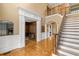 Welcoming foyer featuring hardwood floors, staircase with decorative railings, and archway at 19 Troup Ct, Acworth, GA 30101