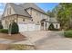 Spacious three-car garage with white doors and side entrance to the home at 19 Troup Ct, Acworth, GA 30101