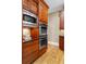 Stainless steel microwave and ovens integrated into dark wood cabinetry, providing modern convenience at 19 Troup Ct, Acworth, GA 30101