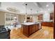 Spacious kitchen featuring a large island with seating, pendant lighting, and hardwood floors at 19 Troup Ct, Acworth, GA 30101