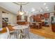 Bright kitchen with a breakfast nook featuring a modern table and chairs, alongside dark wood cabinets and hardwood floors at 19 Troup Ct, Acworth, GA 30101