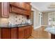 Gourmet kitchen with rich wood cabinetry, granite counters, and a stainless steel cooktop at 19 Troup Ct, Acworth, GA 30101