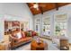 Open living room with kitchen view, hardwood floors, and plenty of natural light from large windows at 19 Troup Ct, Acworth, GA 30101