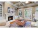 Bright living room featuring a cozy fireplace, built-in shelving, and a plush seating area at 19 Troup Ct, Acworth, GA 30101