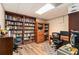 Basement office features dark wood bookshelves, plank flooring, and built in cabinets, ideal for a home office at 4150 E East Chapel Hill Rd, Douglasville, GA 30135