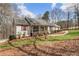Quaint single-story home with wood porch and walkway with verdant landscaping at 4150 E East Chapel Hill Rd, Douglasville, GA 30135