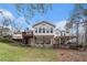 View of the back of the house with large deck and porch overlooking a sloped lawn at 4150 E East Chapel Hill Rd, Douglasville, GA 30135