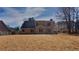 Backyard view of the home showcasing a large grassy area at 450 Pebble Blvd, Covington, GA 30016