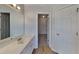 Bright bathroom featuring a large single sink vanity and a doorway to the next room at 450 Pebble Blvd, Covington, GA 30016
