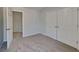 Bedroom featuring carpeted floors, a closet with double doors, and an open doorway at 450 Pebble Blvd, Covington, GA 30016