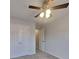 Bedroom with a ceiling fan, carpeted floors, and a closet with double doors at 450 Pebble Blvd, Covington, GA 30016