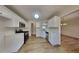 Modern kitchen features stainless steel appliances, white cabinetry, and hardwood floors at 450 Pebble Blvd, Covington, GA 30016