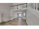 Open-concept living room boasts hardwood floors, stairs to loft, and view to dining area at 450 Pebble Blvd, Covington, GA 30016