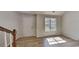 Living room features hardwood floors, a large window, and a view of the staircase at 450 Pebble Blvd, Covington, GA 30016