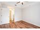 Bright bedroom has wooden floors, ceiling fan, and door to an ensuite bathroom at 50 Biscayne Nw Dr # 5112, Atlanta, GA 30309