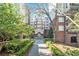 Elegant brick apartment building with a meticulously landscaped walkway leading to the entrance at 50 Biscayne Nw Dr # 5112, Atlanta, GA 30309