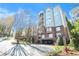 Luxury condo building with brick accents, multiple balconies, and mature trees for privacy at 50 Biscayne Nw Dr # 5112, Atlanta, GA 30309