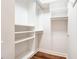 A walk-in closet with white shelving and wood floors offers ample storage space at 50 Biscayne Nw Dr # 5112, Atlanta, GA 30309