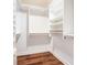 Walk-in closet with custom shelving and wooden floors offers storage options at 50 Biscayne Nw Dr # 5112, Atlanta, GA 30309