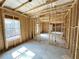 Unfinished basement with lumber framing and large window overlooking the wooded lot at 66 Pine Creek Ct, Dallas, GA 30157