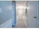 Bright hallway with neutral paint, decorative molding, and tiled floor at 240 Renaissance Ne Pkwy # 112, Atlanta, GA 30308