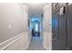 Well-lit hallway featuring neutral paint, white trim, and tiled floors at 240 Renaissance Ne Pkwy # 112, Atlanta, GA 30308