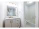 Bathroom featuring a vanity with marble countertop, brass fixtures, and a tub/shower combo at 2411 Charleston Oaks Ln, Decatur, GA 30030
